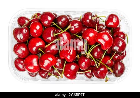 Fresh cherries in a plastic container. Ready to eat, red and ripe fruits of the true cherry species Prunus avium, a stone fruit cultivar. Close-up. Stock Photo