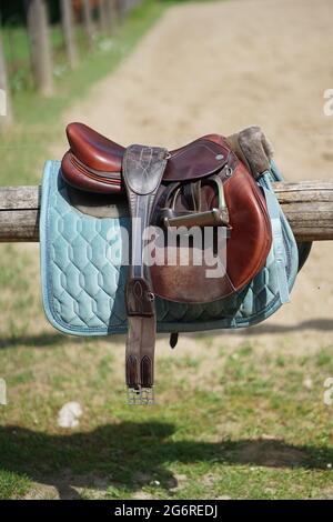 Brown leather horse saddle at equestrian farm Stock Photo