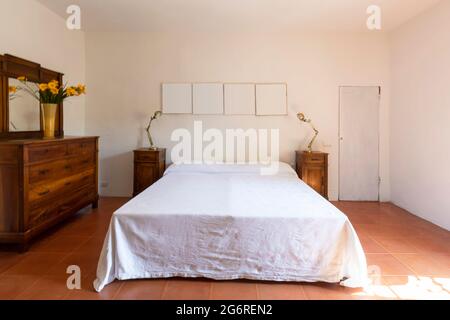 Interior of a double bedroom in a rustic and country style. We are in Italy. Nobody inside Stock Photo