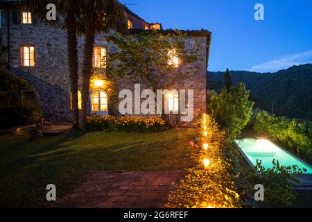 House or cottage at sunset with a beautiful garden in Tuscany. The place is romantic and makes you dream. It is almost evening the silence can be hear Stock Photo