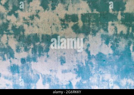 Blue green spoted exposed wall texture.Empty old stained art texture of plaster brick wall background. Stock Photo