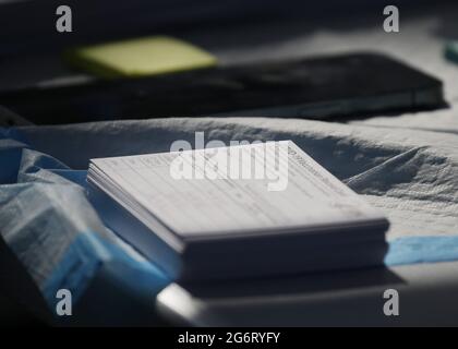 Brooklyn, United States. 08th July, 2021. Vaccination cards sit on a table when Amazon Studios and health tech startup Carbon Health host a series of pop-up vaccination sites across New York City and Los Angeles to increase vaccine accessibility within the cities' underserved populations in New York City on Thursday, July 8, 2021. Photo by John Angelillo/UPI Credit: UPI/Alamy Live News Stock Photo