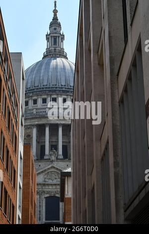 A view of St Paul's sandwiched between two rows of modern buildings
