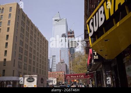 New York, NY, USA - July 8, 2021: Looking north from stores on 10th Ave towards Hudson Yards supertall skyscrapers Stock Photo