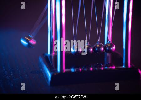 Newton cradle. Demonstrating gravity, action and reaction principle in physics. Stock Photo