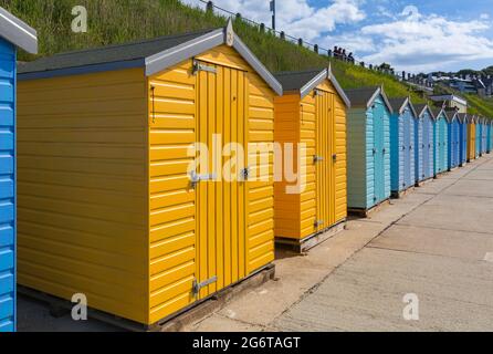 Colourful beach huts at Castle Beach on a warm sunny day at Falmouth, Cornwall UK in June Stock Photo