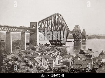 A late 19th century view from North Queensferry of the Forth Bridge, a cantilever railway bridge across the Firth of Forth in the east of Scotland.It was designed by the English engineers Sir John Fowler and Sir Benjamin Baker and construction of the bridge began in 1882 and it was opened on 4 March 1890 by the Duke of Rothesay, the future Edward VII. The bridge carries the Edinburgh–Aberdeen line across the Forth between the villages of South Queensferry and North Queensferry and has a total length of 8,094 feet. When opened it had the longest single cantilever bridge span in the world. Stock Photo