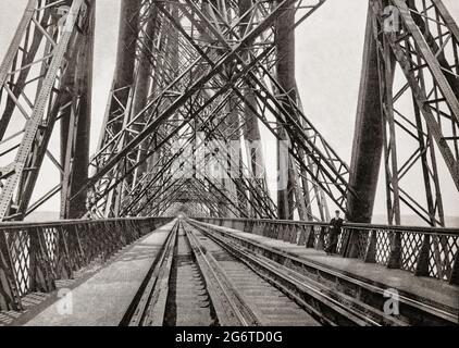 A late 19th century view of the Forth Bridge, a cantilever railway bridge across the Firth of Forth in the east of Scotland.It was designed by the English engineers Sir John Fowler and Sir Benjamin Baker and construction of the bridge began in 1882 and it was opened on 4 March 1890 by the Duke of Rothesay, the future Edward VII. The bridge carries the Edinburgh–Aberdeen line across the Forth between the villages of South Queensferry and North Queensferry and has a total length of 8,094 feet (2,467 m). When opened it had the longest single cantilever bridge span in the world. Stock Photo