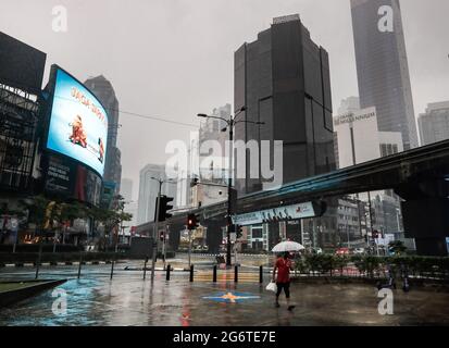 Kuala Lumpur, Malaysia. 08th July, 2021. A pedestrian using an umbrella, walks along a deserted street during heavy downpour in downtown. (Photo by Wong Fok Loy/SOPA Images/Sipa USA) Credit: Sipa USA/Alamy Live News Stock Photo
