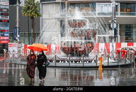 Kuala Lumpur, Malaysia. 08th July, 2021. Pedestrians with an umbrella walking along a deserted street during heavy downpour in downtown. (Photo by Wong Fok Loy/SOPA Images/Sipa USA) Credit: Sipa USA/Alamy Live News Stock Photo