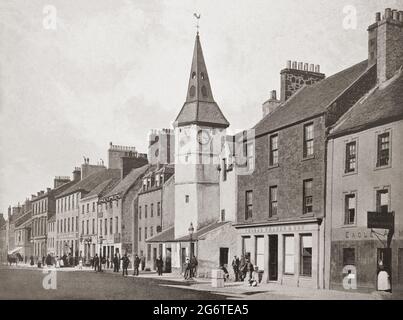 A late 19th century view of the Town Hall in Dunbar, a town on the North Sea coast in East Lothian in the south-east of Scotland. Called the Town House it is thought to date after 1650 and the vaulted ground floor was formerly the tolbooth and now housed the municipal offices. In the council chamber, which lies above, are painted wooden panels depicting the arms of the Union, one of which is dated 1686.