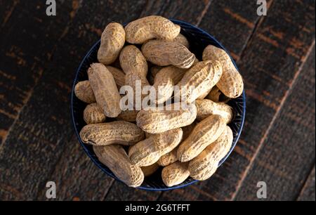 Raw In Shell Peanuts on a Rustic Wooden Kitchen Table Stock Photo