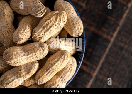 Raw In Shell Peanuts on a Rustic Wooden Kitchen Table Stock Photo