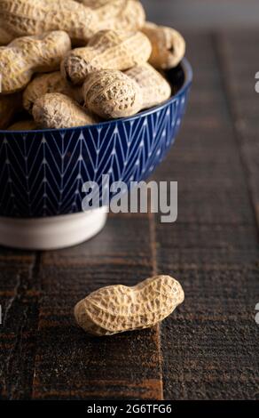 Raw In Shell Peanuts on a Rustic Wooden Kitchen Table Stock Photo