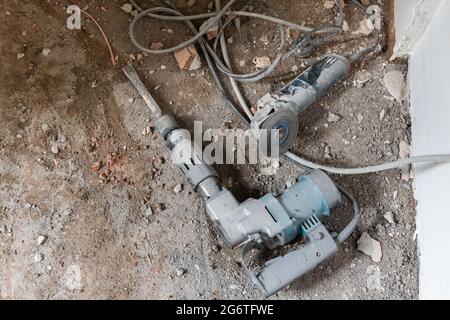 Industrial chipping hammer drill and disc cutter key tools in construction demolishment work Stock Photo