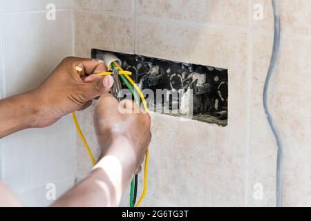 Series of electrician install and mount electrical power socket onto wall Stock Photo