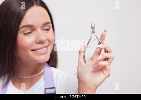 Close up of female manicurist holding nail nippers Stock Photo