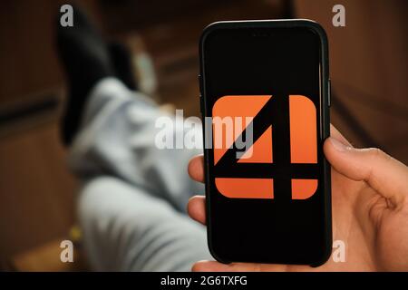 Adam4Adam logo of dating application on the screen of mobile phone in males hand, June 2021, San Francisco, USA Stock Photo