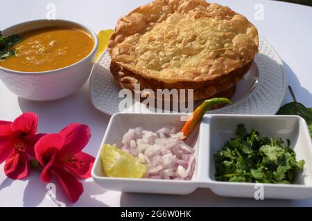 Popular delicious Sindhi cuisine dish item Dal pakwan with chopped Onions, coriander, green chilly. Sindhi authentic food served in platter during bre Stock Photo