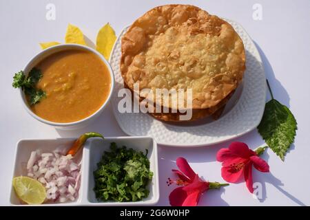 Popular delicious Sindhi cuisine dish item Dal pakwan with chopped Onions, coriander, green chilly. Sindhi authentic food served in platter during bre Stock Photo