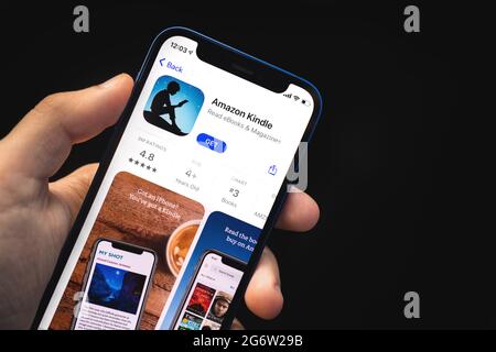 Kharkov, Ukraine - June 4, 2021: Amazon kindle app, man holds mobile phone with application on screen Stock Photo