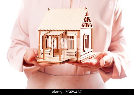 Woman holds model at home in palm, isolate Stock Photo