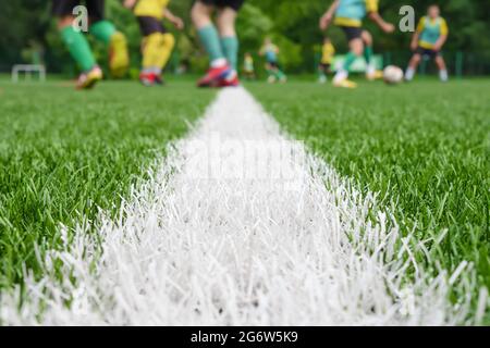 Team on football ground. Match training school soccer field lines. Young footballers on pitch playing football court players soccer background. Pitch Stock Photo