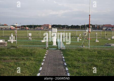 meteorological equipment and sensors placed in a wide and spacious meteorological instrument park. This equipment is used to obtain meteorological and Stock Photo