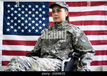 Patriotic Young Veteran Soldier In Wheel Chair Stock Photo