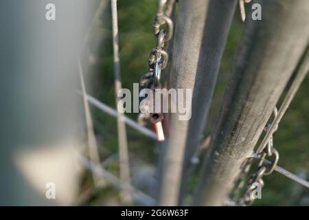 The lock that was released from the chain that bound the iron door. Sign of freedom. The photo is take with bokeh foreground Stock Photo