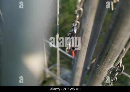 The lock that was released from the chain that bound the iron door. Sign of freedom. The photo is take with bokeh foreground Stock Photo