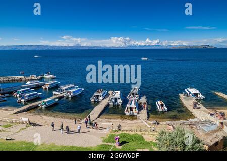 ISLA DEL SOL, BOLIVIA - MAY 12, 2015: Tourists boats anchored in Yumani village on Isla del Sol (Island of the Sun) in Titicaca lake, Bolivia Stock Photo