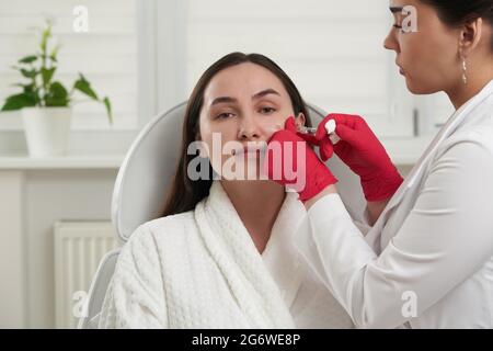 Beautician doing injection for face lifting. Biorevitalization procedure Stock Photo