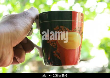 Coffee mug on hand, Stock Photo