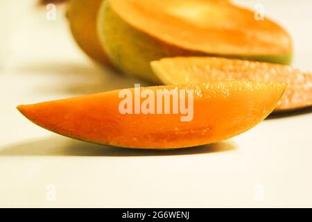 Sliced mango fruits piece on isolated white surface Stock Photo