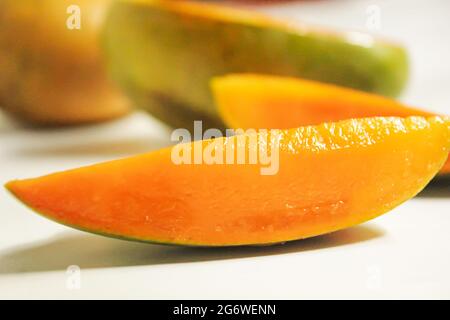 Sliced mango fruits piece on isolated white surface Stock Photo