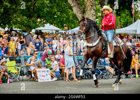 Prescott, Arizona, USA - July 3, 2021: Equestrian rider performing with his horse in the 4th of July parade Stock Photo