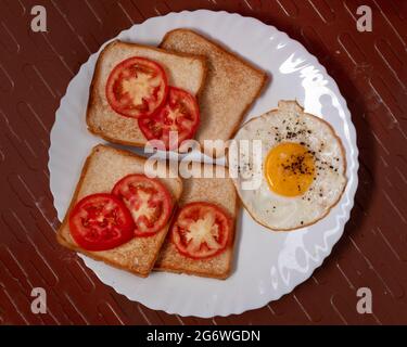 omelet tomato with bread combo Breakfast is the first meal of the day eaten after waking from the night's sleep, usually in the morning Stock Photo