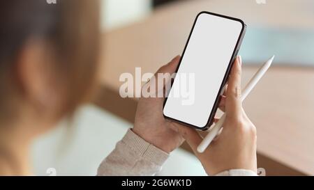 Close up, a girl using smartphone with holding stylus pen Stock Photo