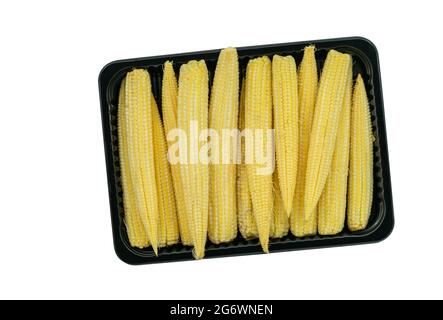 Top view pack of baby corn in a black plastic tray on white background, the isolated image on white background. Fresh baby corn in a black tray for sa Stock Photo