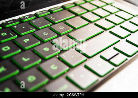 A black color laptop and Q keyboard green light detail, close-up black laptop keyboard Stock Photo