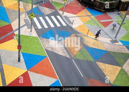 Colourful painted streets in Perth near the WA Museum, viewed from above with a single pedestrian walking Stock Photo