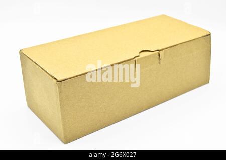 Closed beige rectangular cardboard box with corrugated cardboard lid isolated on white background Stock Photo