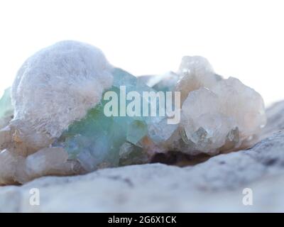 Beautiful minerals and crystals of stilbite and apophyllite partially on a white background. Stock Photo