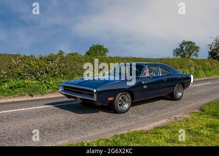 1970 70s blue American Dodge Charger R/T 7200cc muscle car 2dr fastback en-route to Capesthorne Hall classic May car show, Cheshire, UK Stock Photo