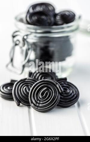Spiral from liquorice candy on white table. Stock Photo