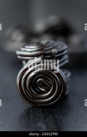 Spiral from liquorice candy on black table. Stock Photo