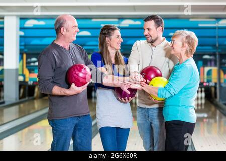 Portrait of smiling family stacking their hands Stock Photo
