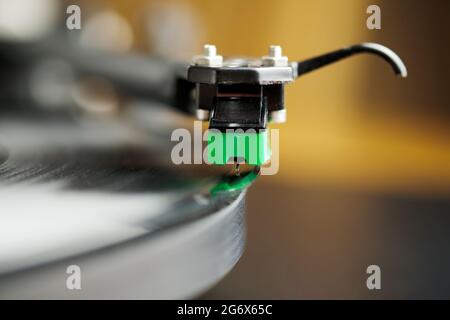 A turntable stylus sitting on the lead in groove of a record or album sitting on a turntable platter. Stock Photo