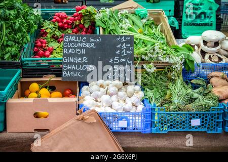 Fresh assorted vegetables and herbs on display at Broadway Market, a street market in Hackney, East London Stock Photo